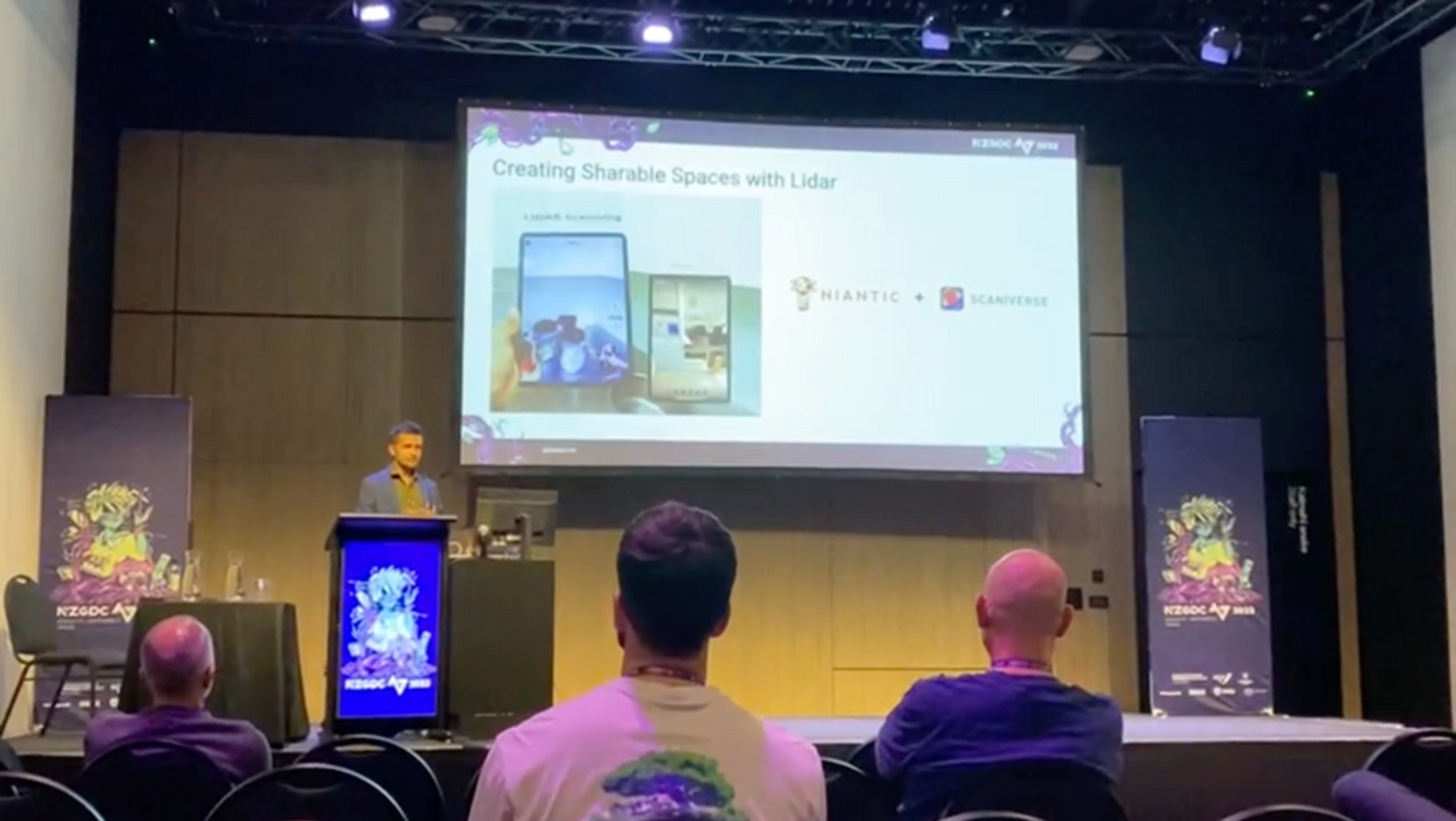 Yasas Sri Wickramasinghe presenting ‘Creating Sharable Spaces with Lidar’ at NZGDC 2023, with the audience in the foreground